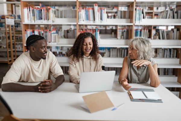 College admissions professionals reviewing enrollment applications and data