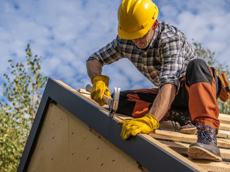 Professional roofer working on home